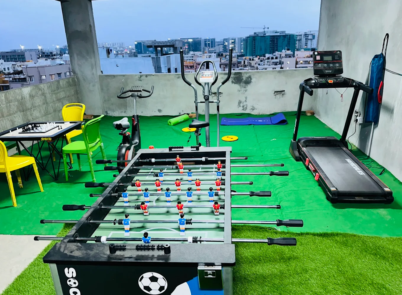 Rooftop gym with treadmill and foosball